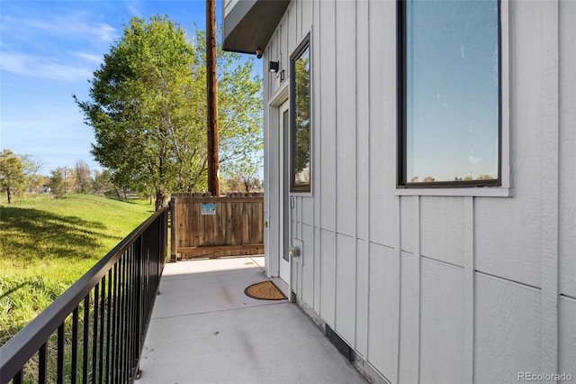 3101 W 47th Ave Unit 13, Denver, CO 80211 - view of side of home with board and batten siding, a balcony, and a lawn