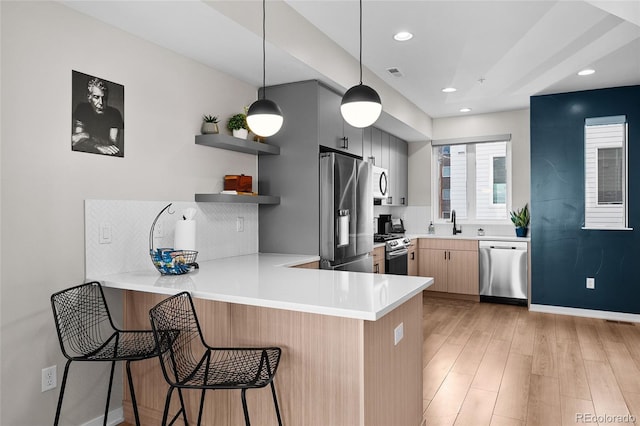 3101 W 47th Ave Unit 13, Denver, CO 80211 - kitchen with appliances with stainless steel finishes, a peninsula, tasteful backsplash, light countertops, and recessed lighting