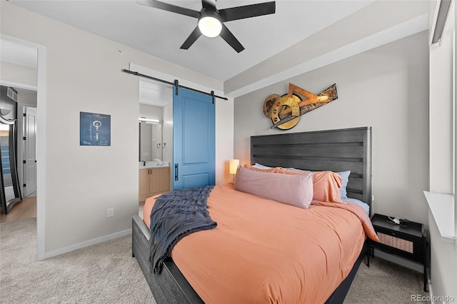 3101 W 47th Ave Unit 13, Denver, CO 80211 - bedroom with a barn door, light carpet, baseboards, ensuite bath, and ceiling fan