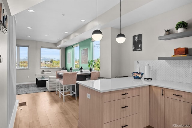 3101 W 47th Ave Unit 13, Denver, CO 80211 - kitchen with open floor plan, a peninsula, light wood finished floors, open shelves, and light countertops