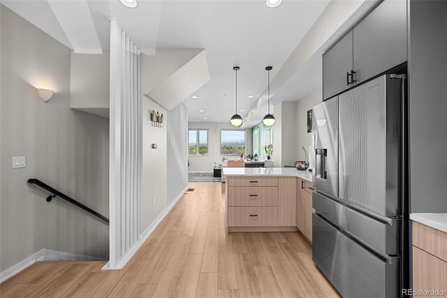 3101 W 47th Ave Unit 13, Denver, CO 80211 - kitchen featuring stainless steel refrigerator with ice dispenser, a peninsula, light brown cabinets, light wood-type flooring, and recessed lighting