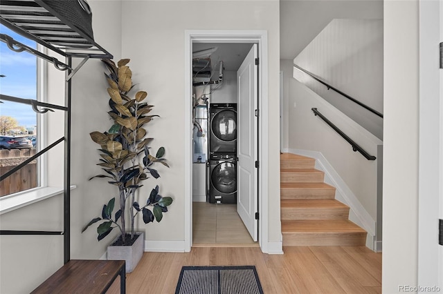 3101 W 47th Ave Unit 13, Denver, CO 80211 - stairs featuring stacked washer and clothes dryer, wood finished floors, and baseboards