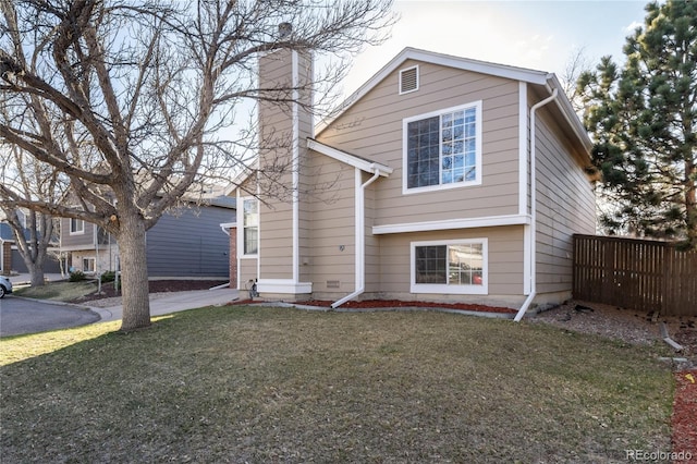 9333 Cattail Ct, Highlands Ranch, CO 80126 - view of front facade with concrete driveway, fence, a chimney, and a front lawn