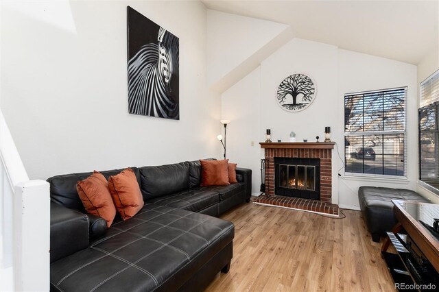 9333 Cattail Ct, Highlands Ranch, CO 80126 - living room with baseboards, a fireplace, high vaulted ceiling, and wood finished floors