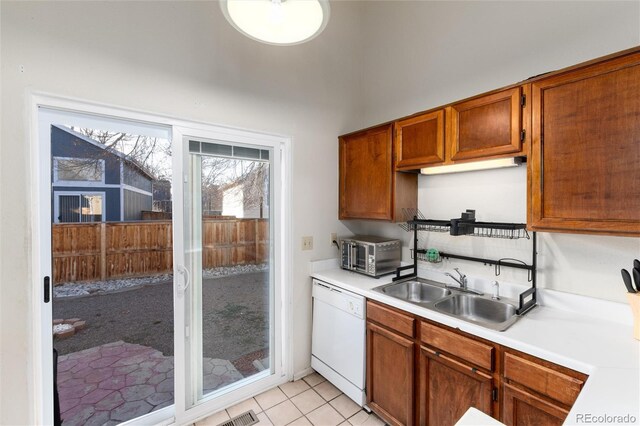 9333 Cattail Ct, Highlands Ranch, CO 80126 - kitchen with brown cabinetry, light countertops, a sink, and dishwasher