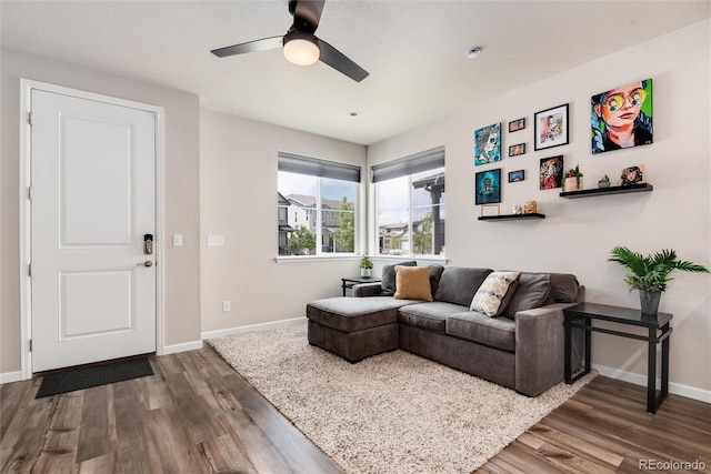 living room featuring dark hardwood / wood-style flooring and ceiling fan