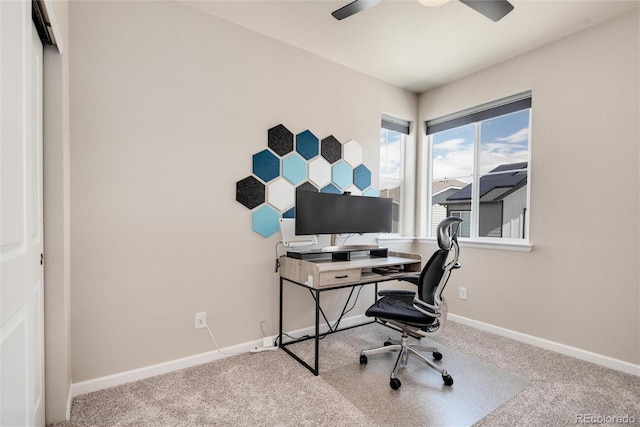 carpeted home office featuring ceiling fan