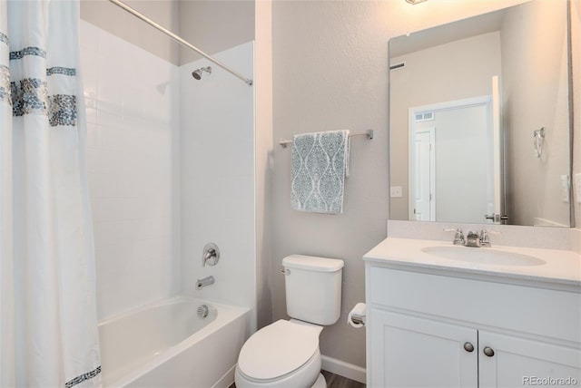 full bathroom with vanity, shower / tub combo, and toilet