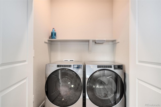 laundry area with washing machine and clothes dryer