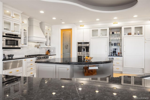 2421 Ranch Reserve Rdg, Denver, CO 80234 - kitchen featuring a warming drawer, custom exhaust hood, appliances with stainless steel finishes, white cabinetry, and recessed lighting