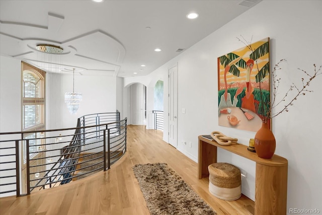 2421 Ranch Reserve Rdg, Denver, CO 80234 - hallway featuring an upstairs landing, arched walkways, wood finished floors, recessed lighting, and a chandelier