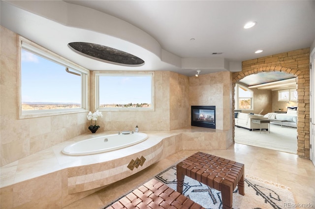 2421 Ranch Reserve Rdg, Denver, CO 80234 - bathroom with a tile fireplace, a bath, tile patterned floors, and recessed lighting