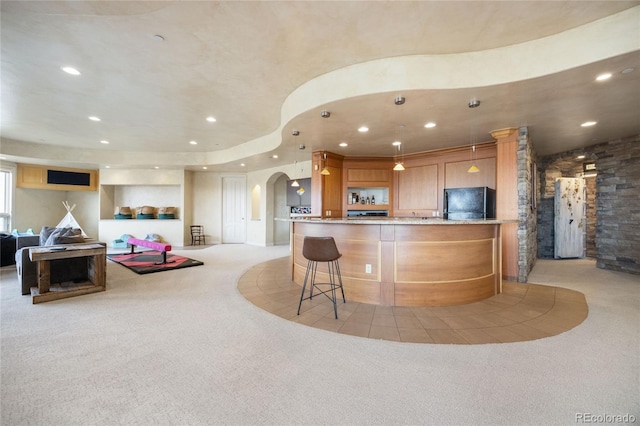 2421 Ranch Reserve Rdg, Denver, CO 80234 - kitchen featuring refrigerator, arched walkways, light colored carpet, recessed lighting, and light stone countertops