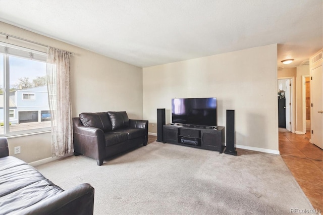 carpeted living area with baseboards