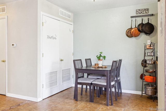 dining area featuring visible vents, baseboards, and tile patterned flooring