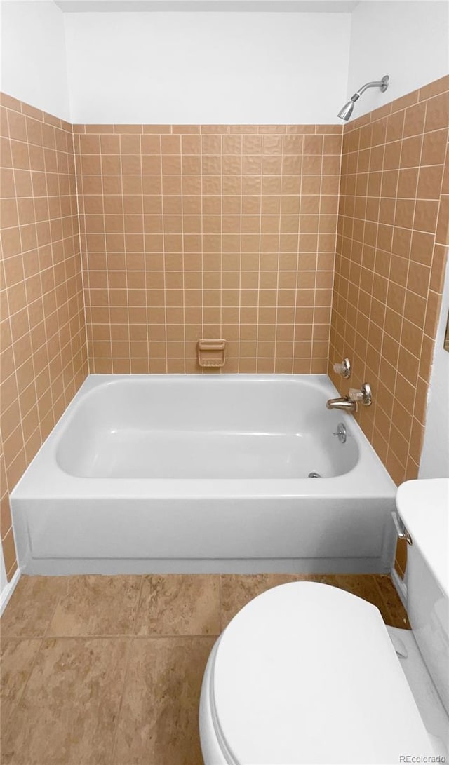 bathroom featuring tile patterned floors, toilet, and tub / shower combination