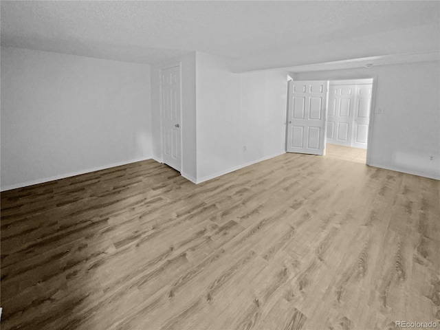 interior space with a textured ceiling and light wood-type flooring