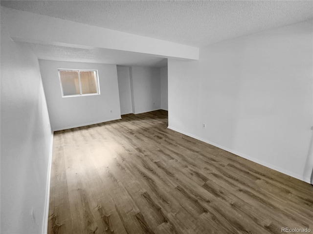 spare room with hardwood / wood-style flooring and a textured ceiling