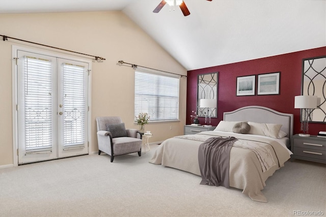 carpeted bedroom featuring french doors, access to exterior, vaulted ceiling, and multiple windows