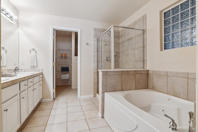 bathroom featuring vanity, shower with separate bathtub, and tile patterned flooring