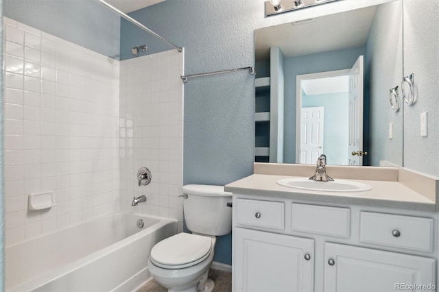 full bathroom featuring tiled shower / bath combo, vanity, and toilet