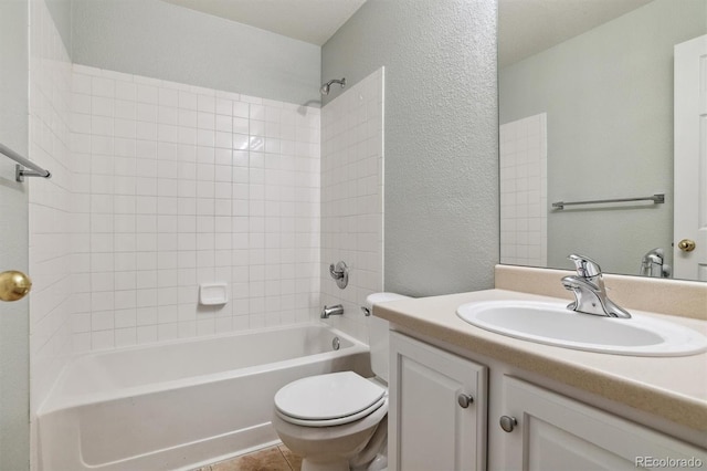 full bathroom featuring tile patterned floors, vanity, toilet, and tiled shower / bath combo