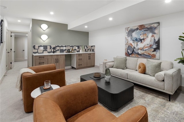 carpeted living room with sink