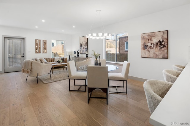 dining room featuring a chandelier, light hardwood / wood-style floors, and plenty of natural light