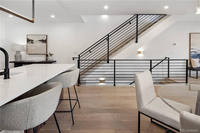 stairs featuring hardwood / wood-style floors