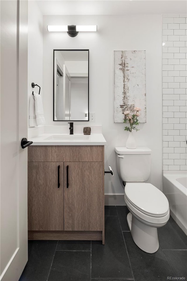 bathroom featuring toilet, tile patterned floors, and vanity