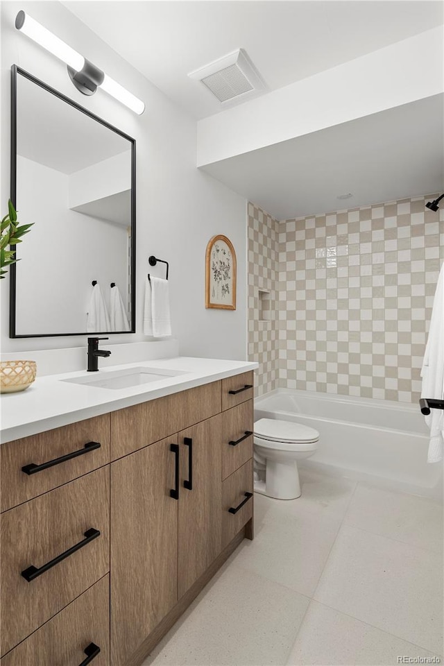 full bathroom featuring toilet, vanity,  shower combination, and tile patterned flooring