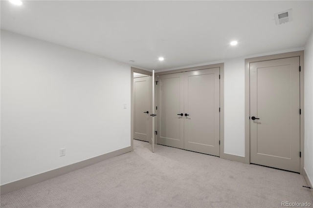 unfurnished bedroom featuring light carpet