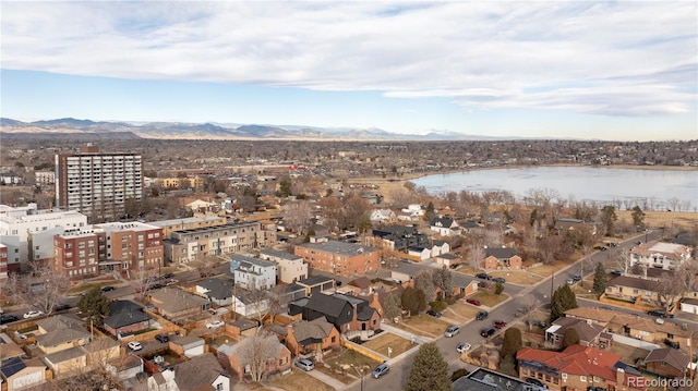 drone / aerial view featuring a water and mountain view