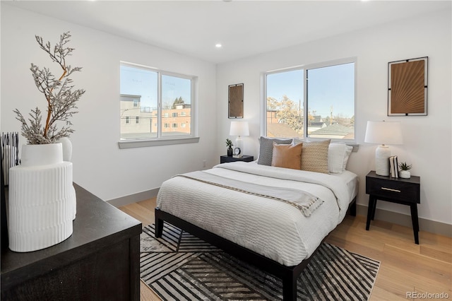 bedroom featuring multiple windows and light wood-type flooring