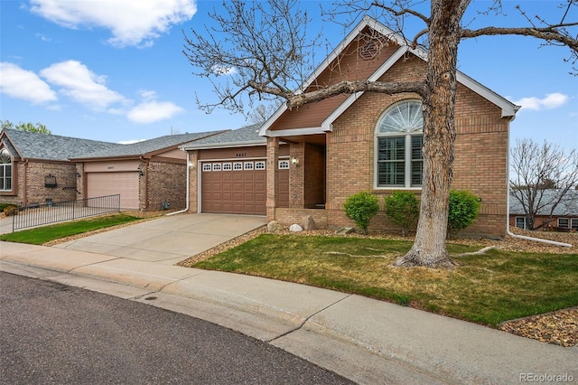 ranch-style home featuring brick siding, a garage, a front yard, and concrete driveway