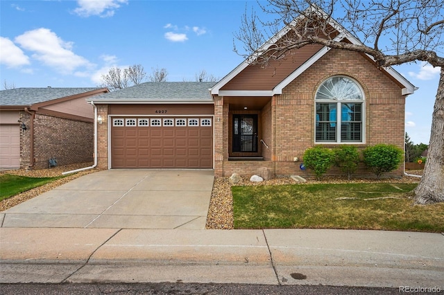 ranch-style house with brick siding, a garage, a front lawn, and concrete driveway