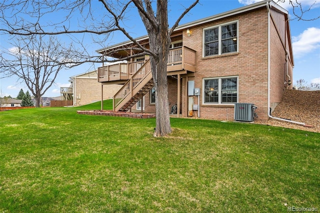 back of property featuring a wooden deck, brick siding, central AC, a yard, and stairs