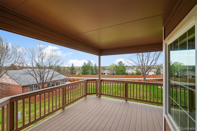 wooden deck with fence, a yard, and a residential view