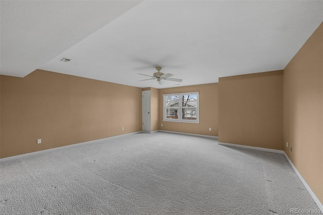 unfurnished room featuring ceiling fan, light colored carpet, baseboards, and visible vents