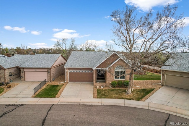 single story home featuring brick siding, an attached garage, and concrete driveway