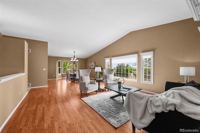 4927 Greenwich Way, Highlands Ranch, CO 80130 - living room featuring light wood-style flooring, a chandelier, and lofted ceiling