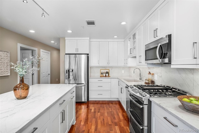 1631 N Emerson St Unit 117, Denver, CO 80218 - kitchen featuring white cabinetry, appliances with stainless steel finishes, a sink, and visible vents