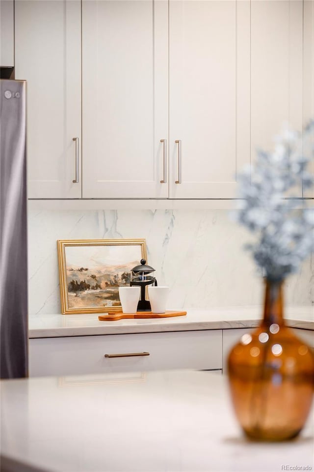 1631 N Emerson St Unit 117, Denver, CO 80218 - room details featuring light countertops, white cabinetry, and tasteful backsplash