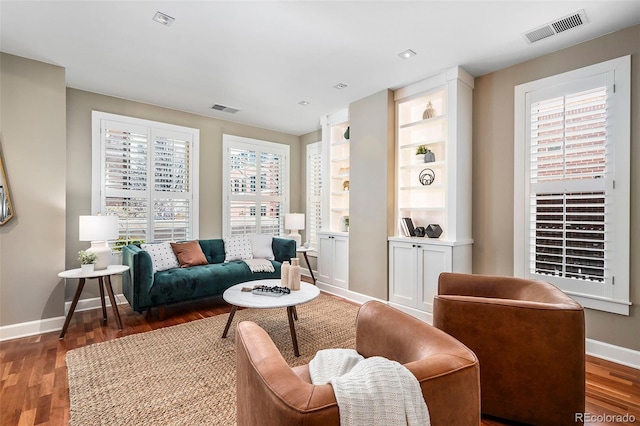 1631 N Emerson St Unit 117, Denver, CO 80218 - living area with baseboards, wood finished floors, and visible vents