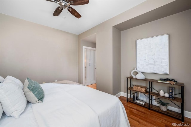1631 N Emerson St Unit 117, Denver, CO 80218 - bedroom with wood finished floors, a ceiling fan, and baseboards