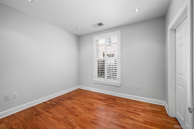 1631 N Emerson St Unit 117, Denver, CO 80218 - unfurnished bedroom featuring wood finished floors, visible vents, and baseboards