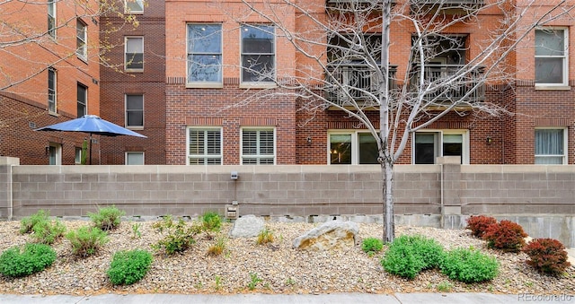 1631 N Emerson St Unit 117, Denver, CO 80218 - view of home's exterior with fence and brick siding