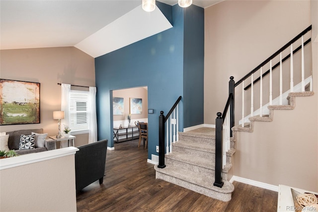 interior space featuring dark wood-style floors, stairs, baseboards, and vaulted ceiling