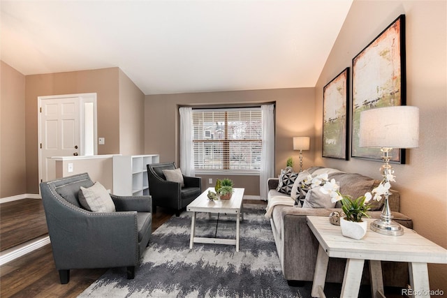 living room with vaulted ceiling, baseboards, and wood finished floors