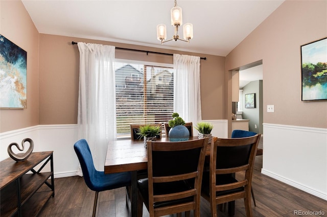 dining room with dark wood finished floors, a notable chandelier, and lofted ceiling